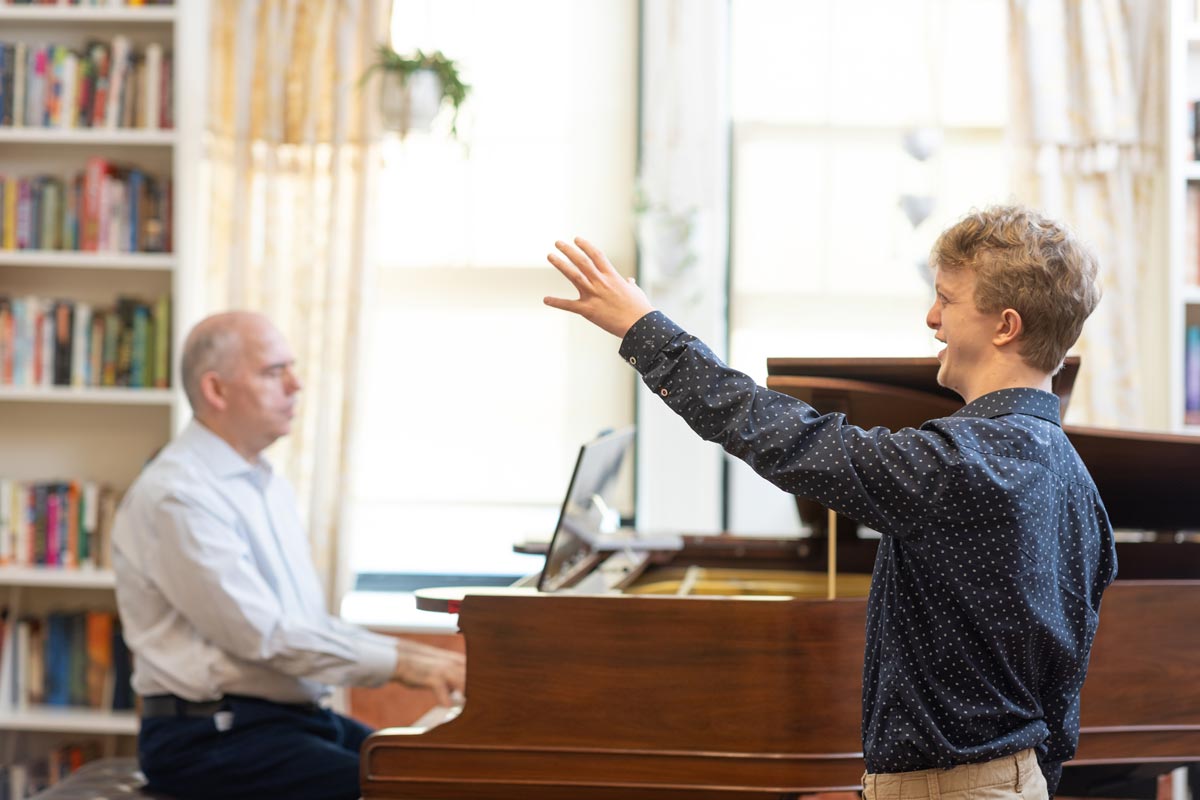 Peter Muir with John in a lesson, John singing