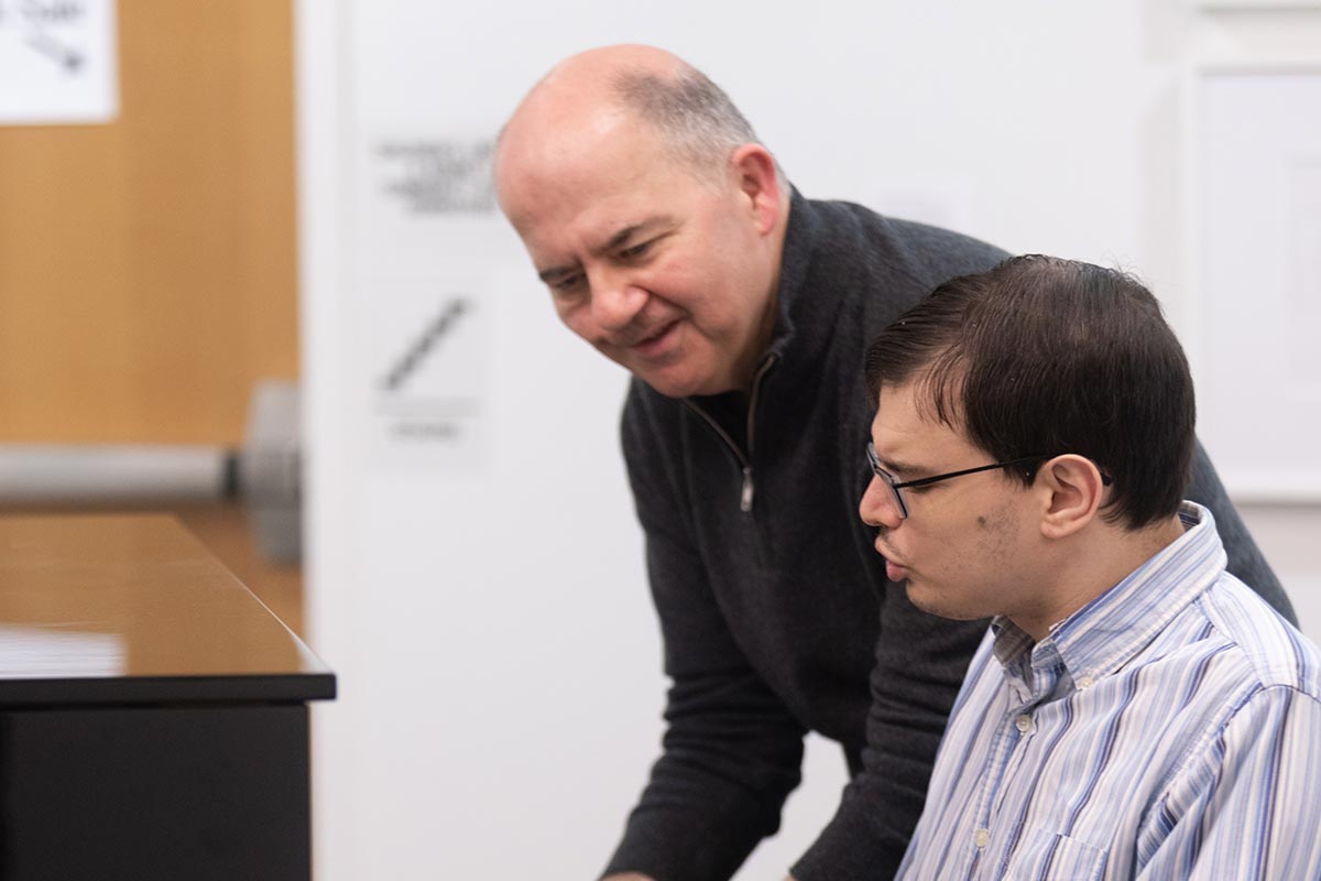 Peter Muir with Michael in a lesson