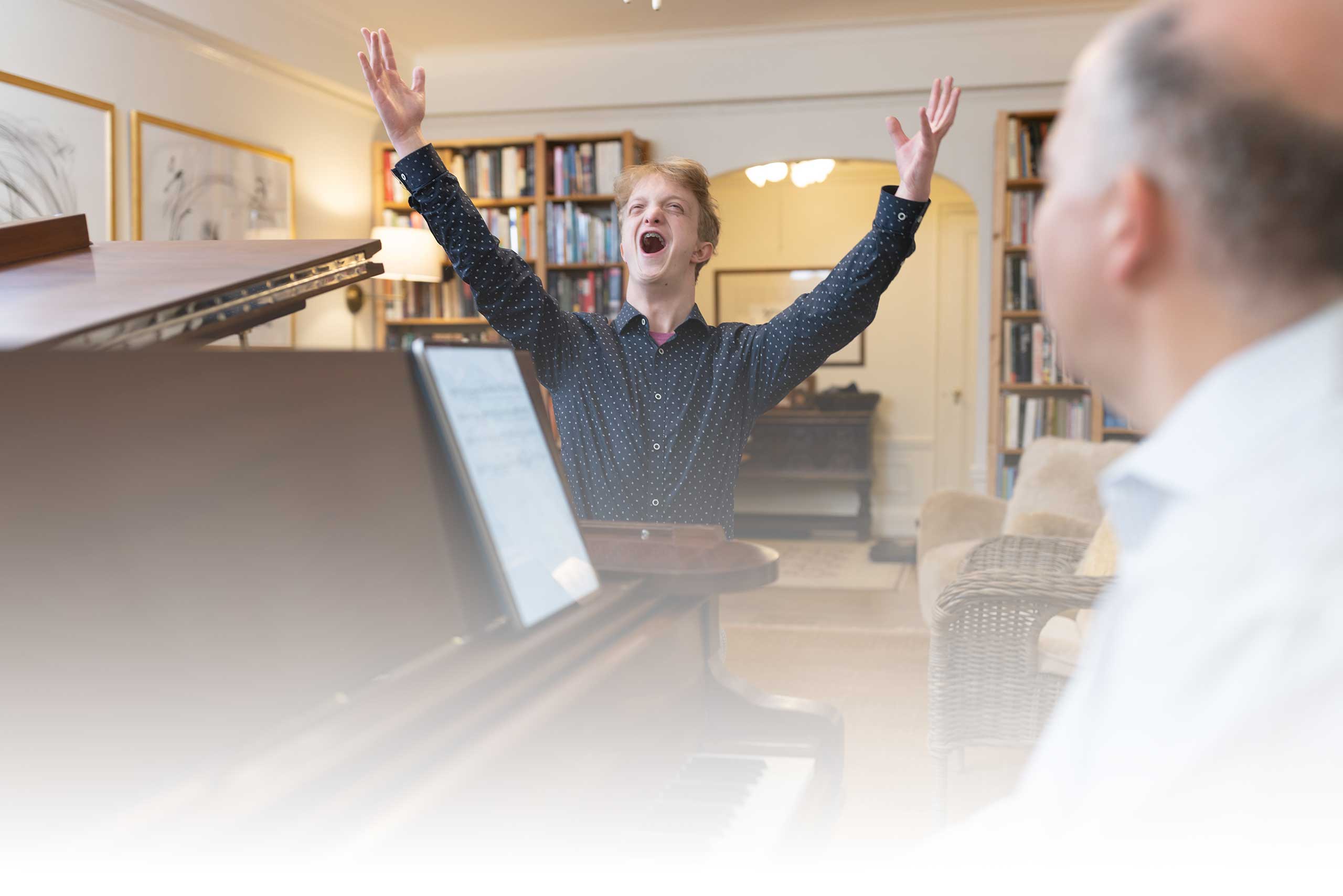 music lesson with Peter Muir playing the piano and John singing happily