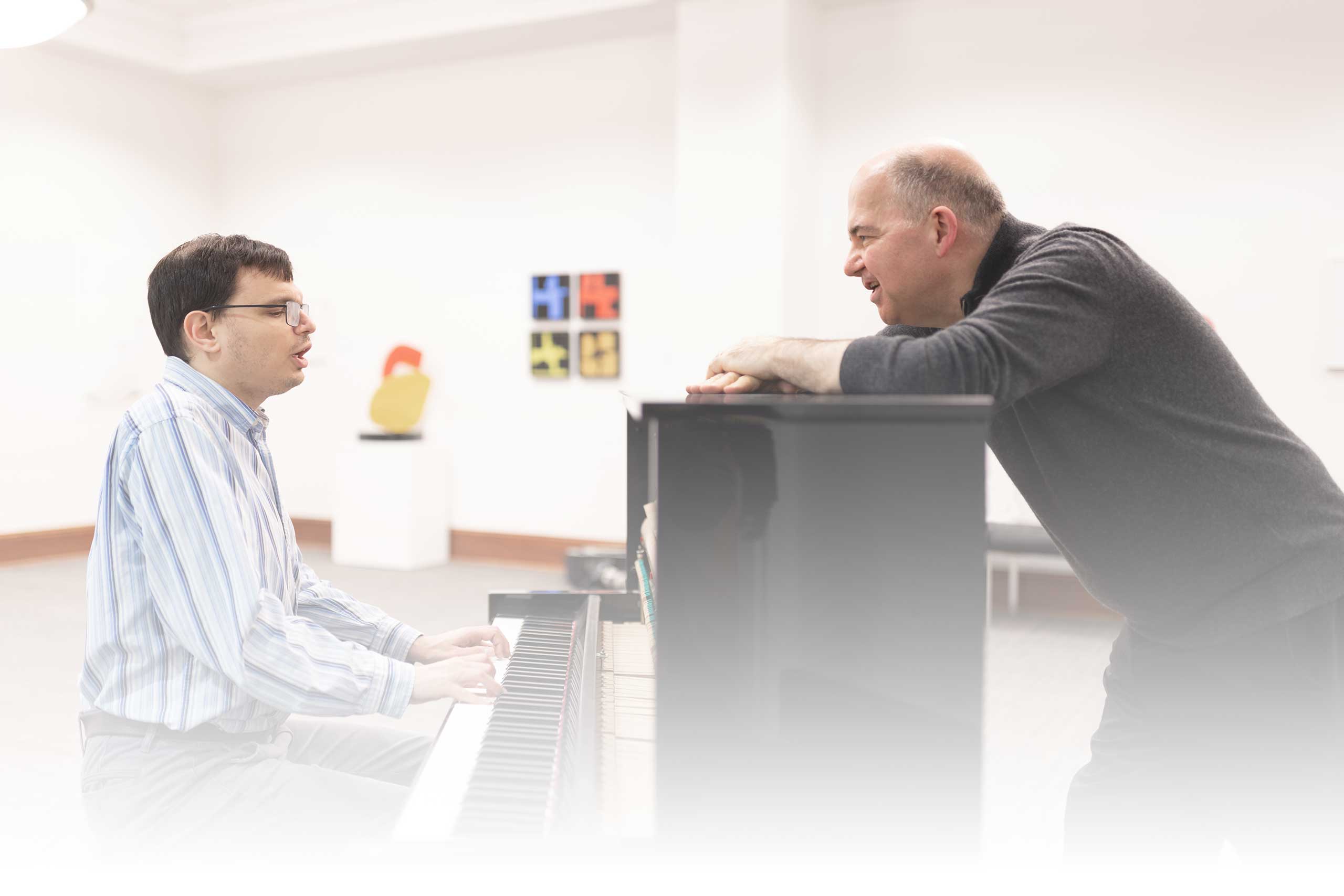piano music lesson with Peter Muir overseeing Michael playing the piano